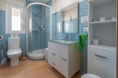 a bathroom with a sink and a toilet and a shower at Terraza Estampa de Cádiz in Cádiz