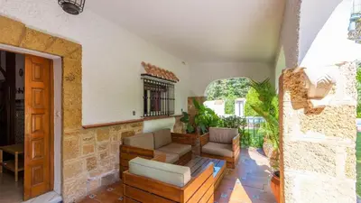 a living room with a couch and a chair at Villa Las Carmenes Conil de la Frontera by Ruralidays in Conil de la Frontera