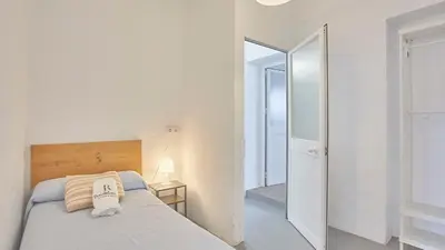 a white bedroom with a bed and a mirror at Cortijo de Liche Arcos de la Frontera by Ruralidays in Arcos de la Frontera