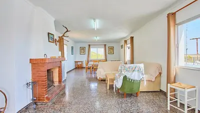 a living room with a fireplace and a bedroom at Cortijo de Liche Arcos de la Frontera by Ruralidays in Arcos de la Frontera