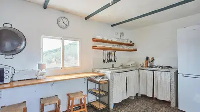 a kitchen with a counter and a sink and a window at Cortijo de Liche Arcos de la Frontera by Ruralidays in Arcos de la Frontera