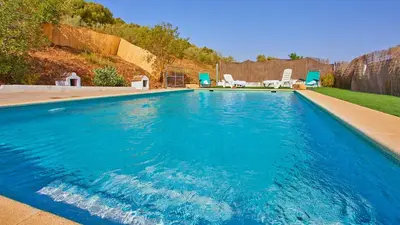 a swimming pool with blue water in a yard at Cortijo de Liche Arcos de la Frontera by Ruralidays in Arcos de la Frontera