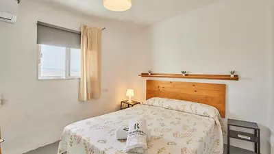 a bedroom with a bed with a pair of shoes on it at Cortijo de Liche Arcos de la Frontera by Ruralidays in Arcos de la Frontera