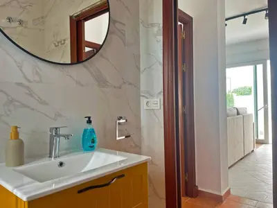 a bathroom with a sink and a mirror at Villa Nostos - Ole Solutions in Cádiz