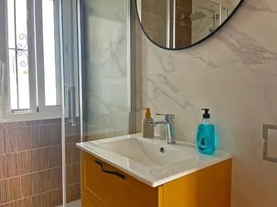 a bathroom with a sink and a mirror at Villa Nostos - Ole Solutions in Cádiz