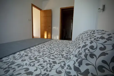 a bedroom with a bed and a dresser and a window at Hacienda Laguna Seca - Apart. Hibisco in Chiclana de la Frontera