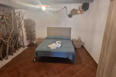 a bedroom with a bed with a stuffed animal on it at Chalet a 2 kilometros de la playa in Chiclana de la Frontera
