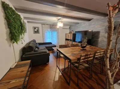 a living room with a table and a couch at Chalet a 2 kilometros de la playa in Chiclana de la Frontera