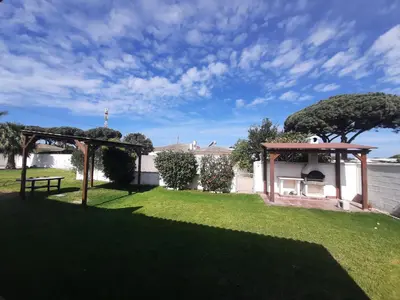 a garden with a picnic table and a gazebo at Chalet La Alberca in Chiclana de la Frontera