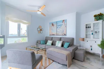a living room with a couch and two chairs at Genteel Home Victoria in Cádiz