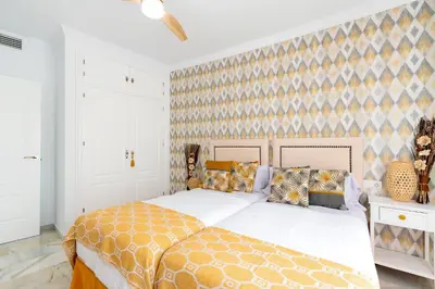 a bedroom with a large bed and a wall at Genteel Home Victoria in Cádiz