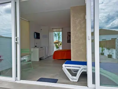 a room with a sliding glass door with a bedroom at Apartamento Klandestina - Ole Solutions in Cádiz