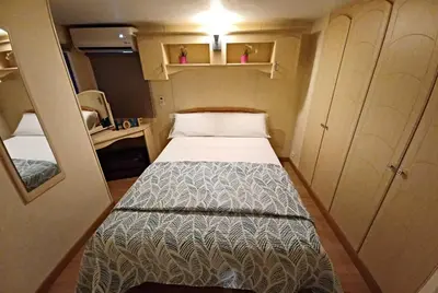a small bedroom with a bed in a small room at OHANA in Chiclana de la Frontera