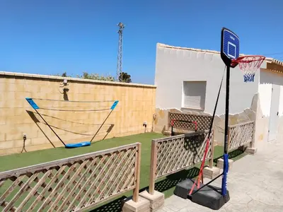 a basketball hoop with a net in a backyard at OHANA in Chiclana de la Frontera