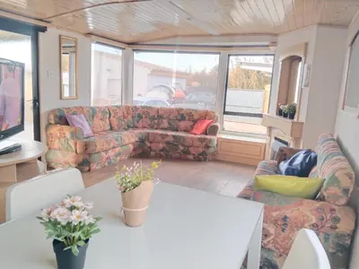 a living room with a couch and a table at OHANA in Chiclana de la Frontera