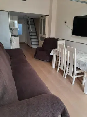 a living room with a couch and a table at Loft Las piletas in Sanlúcar de Barrameda