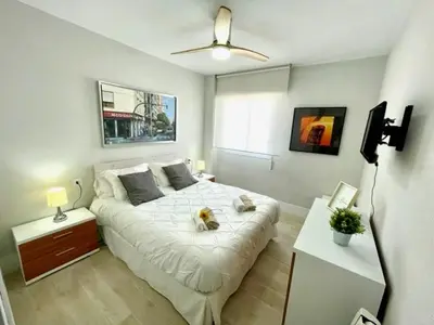 a bedroom with a bed with a dog on it at GATU Villa Salada, junto la playa, parking, terraza, aire acc, piscina, wifi Sólo familias o grupos mayores de 21 años in El Puerto de Santa María