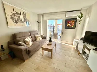 a living room with a couch and a table at GATU Villa Salada, junto la playa, parking, terraza, aire acc, piscina, wifi Sólo familias o grupos mayores de 21 años in El Puerto de Santa María