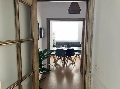 a dining room with a table and chairs and a mirror at Piso en el centro in San Fernando