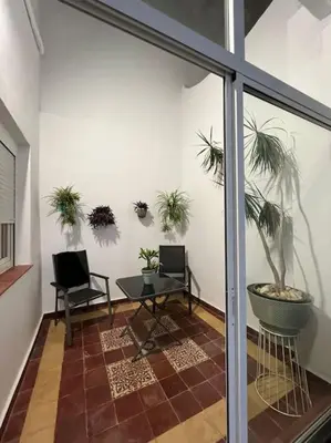 a room with a table and potted plants on the wall at APARTAMENTO VEEDOR BUENAS COMPAÑIAS in Cádiz
