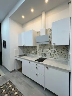 a kitchen with white cabinets and a counter top at APARTAMENTO VEEDOR BUENAS COMPAÑIAS in Cádiz