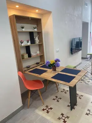 a wooden table with a red chair in a room at APARTAMENTO VEEDOR BUENAS COMPAÑIAS in Cádiz