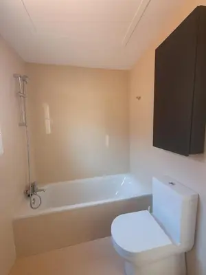 a bathroom with a toilet and a bath tub at Villa Ostrero in Chiclana de la Frontera