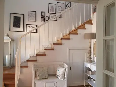 a stairway with a bench under a staircase with a stair case at Villa Ostrero in Chiclana de la Frontera