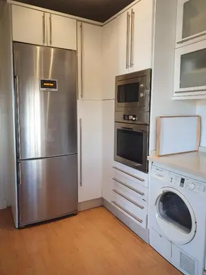 a kitchen with a stainless steel refrigerator and a dishwasher at Villa Ostrero in Chiclana de la Frontera