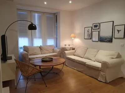 a living room with two couches and a table at Villa Ostrero in Chiclana de la Frontera