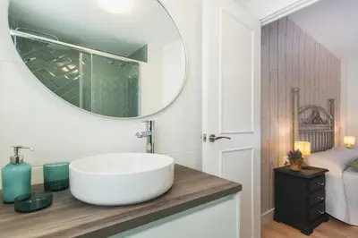 a bathroom with a sink and a mirror on a counter at Las Olas Chipiona in Chipiona