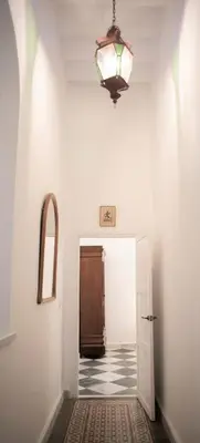 a hallway with a door and a chandelier at GATU PREMIUM Apartamento Palacio Oneto con Jardín Privado 