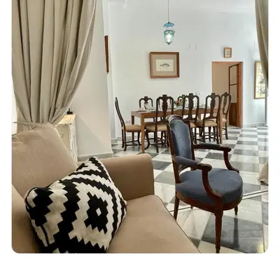 a living room with a couch and a table with chairs at GATU PREMIUM Apartamento Palacio Oneto con Jardín Privado 