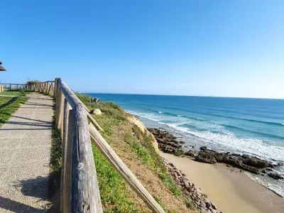 a path next to a beach next to the ocean at Villa Bonita in Conil de la Frontera