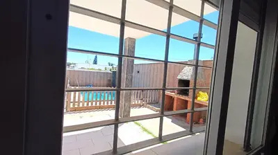 a view from a window looking out onto a balcony at Villa Bonita in Conil de la Frontera