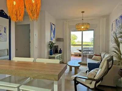 a living room with a table and a dining room at Apartamento Dunas Candor - Ole Solutions in Rota