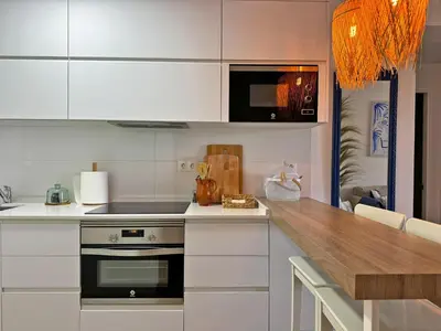 a kitchen with white cabinets and a counter top at Apartamento Dunas Candor - Ole Solutions in Rota