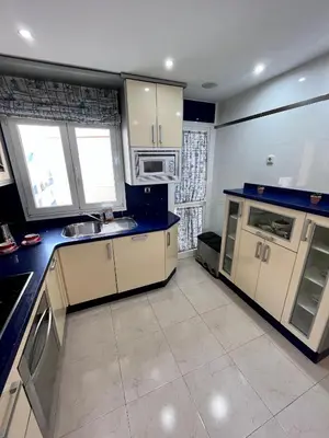 a kitchen with white cabinets and blue counter tops at GATU PREMIUM Villa Turquesa Playa y Parking in Cádiz