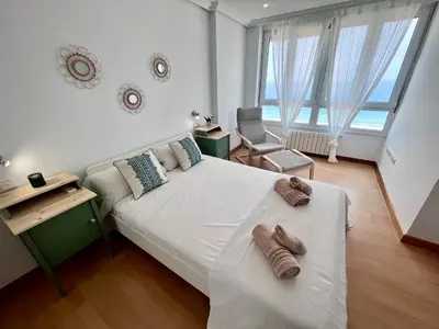 a bedroom with a large bed with shoes on it at GATU PREMIUM Villa Turquesa Playa y Parking in Cádiz