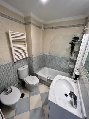a bathroom with a sink and a toilet and a tub at GATU PREMIUM Villa Turquesa Playa y Parking in Cádiz