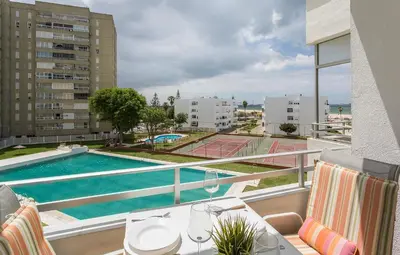 a balcony with a view of a pool and buildings at Azvalia - Valdelagrana Puerto Príncipe, Playa, piscina, parking in El Puerto de Santa María
