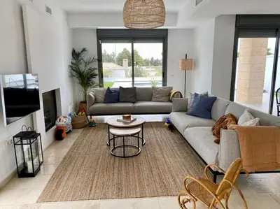 a living room with a couch and a table at Exclusiva Villa Lujo con piscina privada by Chiclana Dreams in Chiclana de la Frontera