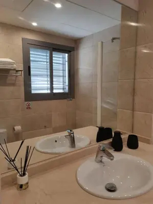 a bathroom with a sink and a tub and a mirror at Exclusiva Villa Lujo con piscina privada by Chiclana Dreams in Chiclana de la Frontera
