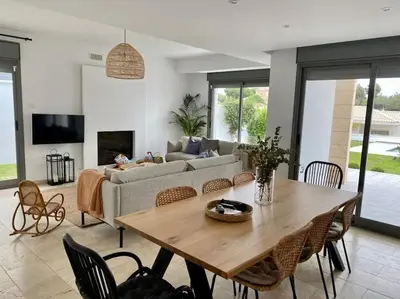 a living room with a table and a couch at Exclusiva Villa Lujo con piscina privada by Chiclana Dreams in Chiclana de la Frontera