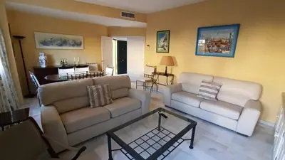 a living room with two couches and a table at Villa Mar de Las Redes in El Puerto de Santa María