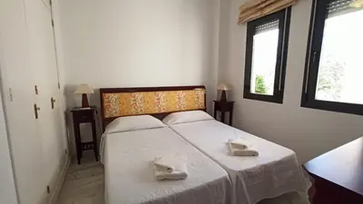 a bedroom with a bed with two towels on it at Villa Mar de Las Redes in El Puerto de Santa María