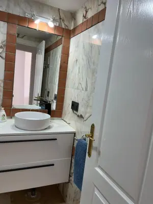 a bathroom with a white sink and a mirror at Margaritas 27 in Chiclana de la Frontera