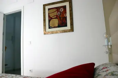a picture hanging on a white wall next to a couch at Mi UNIVERSO in San Fernando