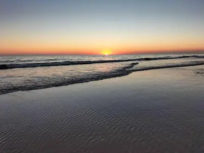 a sunset on a beach with the ocean at Mi UNIVERSO in San Fernando