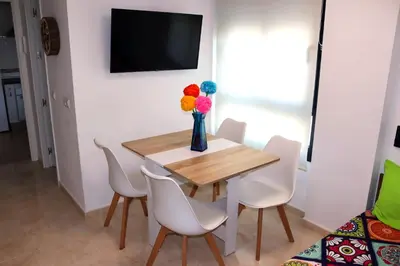 a dining room with a table with chairs and a vase with balloons at Mi UNIVERSO in San Fernando